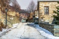 View of traditional stone buildings and streets with snow at the famous village of Nymfaio near Florina, Greece Royalty Free Stock Photo