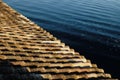 View from traditional tiles rooftop to calm sea waters