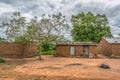 View of traditional village, a coat resting outdoor and zinc sheet on roof houses and terracotta brick walls, cloudy sky as Royalty Free Stock Photo