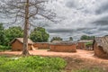 View of traditional village, thatched and zinc sheet on roof houses and terracotta brick walls, cloudy sky as background Royalty Free Stock Photo