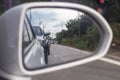 View of a traffic jam on the road in the countryside of Thailand from the view of the car`s side mirror. Royalty Free Stock Photo