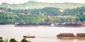 View of traffic of tugboats pulling barge of coal at Mahakam River, Samarinda, Indonesia.