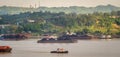 View of traffic of tugboats pulling barge of coal at Mahakam River, Samarinda, Indonesia.