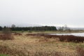 A view of the trail, meadow and river with cyclist in the background Royalty Free Stock Photo