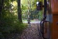 View from the train of an attraction train going through a beautiful forest, in front of you there is a crossing with a barrier Royalty Free Stock Photo