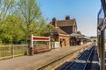 A view from a train carriage window as the train passes a station in the UK