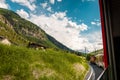 View from train riding through the Swiss Alps. Red panoramic train. Royalty Free Stock Photo