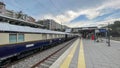 View of a train station with Venice Simplon Orient Express train on the train tracks