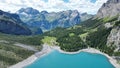 View of a tranquil blue lake surrounded by lush green mountains and trees Royalty Free Stock Photo