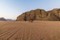 A view of travellers at sunrise in the desert landscape in Wadi Rum, Jordan Royalty Free Stock Photo