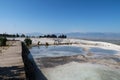 View from the travertine terraces of Pamukkale onto the valley with a paraglider in the background, Denizli, Turkey Royalty Free Stock Photo