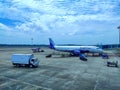 View of Trivandrum airport on one side with the indigo plane and a lorry