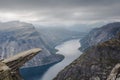 View of Trolltunga cliff and lake between mountains, picturesque landscape, beauty in nature, paradise on Earth, sunny day, Odda, Royalty Free Stock Photo