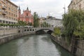 View of the Tromostovje bridge in Ljubljana and several tourists passing by