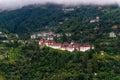 View of Trongsa Dzong and Ta-Dzong with foggy hills, Bumthang, Bhutan, Asia.