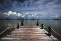 View from tropical island over wood pier on endless ocean water with dramatic storm sky clouds - Thailand, andaman sea Royalty Free Stock Photo