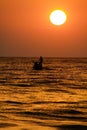 View on tropical sunset with big round sun over ocean horizon, dark shimmering water - Sri Lanka Royalty Free Stock Photo