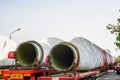 A view of a truck, a low-loader semi-trailer with oversized wind generator parts in the parking lot Royalty Free Stock Photo