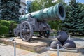 View of the Tsar cannon on a carriage with cast-iron cores against the background of green trees in the Kremlin, Moscow.