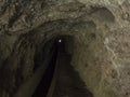 View through tunnel of levada, water irrigation channel at hiking trail Levada do moinho to levada nova waterfall Royalty Free Stock Photo