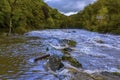 A view of turbulent water from Cenarth up the river Teifi, Wales after heavy rainfall Royalty Free Stock Photo