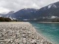 View of turquoise blue creek and foggy mountains Royalty Free Stock Photo