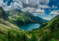 View on the turquoise color lake between high and rocky mountains.