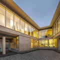 View of the two legs of a sustainable wood office building from the inner courtyard with lighting Royalty Free Stock Photo