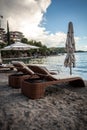 View of two wooden sunbeds with umbrellas on sea beach Royalty Free Stock Photo