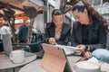 View of two young female colleagues working on a task while sitting in the cafeteria Royalty Free Stock Photo