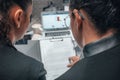 View of two young female students working on a task while sitting in the cafeteria Royalty Free Stock Photo