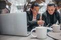 View of two young female students working on a task while sitting in the cafeteria Royalty Free Stock Photo