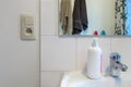 View of a typical bathroom. Bathroom fragment - switch, mirror, faucet, liquid soap Royalty Free Stock Photo