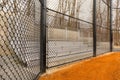 View of typical nondescript high school softball field aluminum bleachers