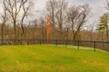 View of typical nondescript high school softball left outfield orange foul pole