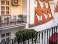 A view of typical Prague house with red tile roof. Balcony and plants Royalty Free Stock Photo