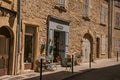 View of typical stone houses and shops on a street of Lourmarin.