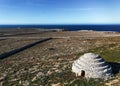 view of the typical stone walls and fields encasing the historic Talayot stone houses on Menorca Island in Spain