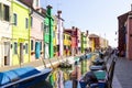 View on typical street scene showing brightly painted houses and boats with reflection along canal Royalty Free Stock Photo