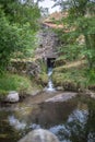 View of a typical watermill, made on granite stone, on the middle at the forest, over river Royalty Free Stock Photo