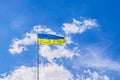 The view on the Ukrainian flag flying over the hill in the Trypillya village