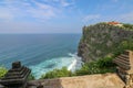 View of Uluwatu cliff with pavilion and blue sea in Bali, Indonesia. Beautiful scenery of Pura Luhur Uluwatu Temple with colorful Royalty Free Stock Photo
