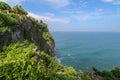 View of Uluwatu cliff with pavilion and blue sea in Bali, Indonesia. Beautiful scenery of Pura Luhur Uluwatu Temple with colorful Royalty Free Stock Photo