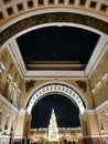 View from under the arch of the General Staff building to the Christmas fir tree on Palace Square, decorated in a retro style with Royalty Free Stock Photo