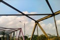 View from under the iron bridge pillars and blue sky during the day.