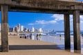 View under pier of beach and city skyline Royalty Free Stock Photo