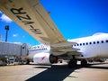 The view under the plane left wing of Qantas domestic airline Aircraft Type: Boeing 737 on the runway. Royalty Free Stock Photo
