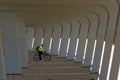 View under symetric bridge with person on bike, background desgin. White color. Architecture. .