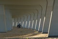 View under symetric bridge with person on bike, background desgin. White color. Architecture. .