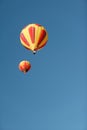 Two colorful hot air balloons against a blue sky. Royalty Free Stock Photo